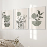 Three framed abstract art pieces with green and black elements on a white wall.