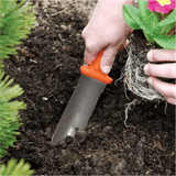 Person planting a plant with a ZenBori Soil Knife in soil