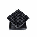 Two black plastic seedling trays stacked on a white background