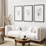 Modern living room with a white sofa, wooden coffee table, and 3 Piece Watercolor Floral Wall Art Set