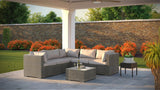 Outdoor patio furniture set with a stone wall and greenery in the background