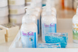 Sea Salt body care products on a shelf with blurred background