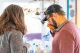 Man and woman looking at a display case with AMBER ALE BEER SOAP SLICE 5 oz.