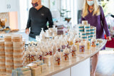 Display of skincare products on a counter with people in the background