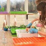 Child working with plants in a greenhouse setting
