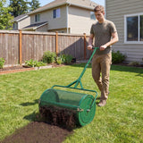 Person using a green 24 Inch Compost Spreader Peat Moss Spreader Roller with Height-Adjustable T-Shaped Handle-Black on a grassy area in front of a house.