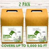Two boxes of Flawn Seed Thick Bee Lawn Seed Kit on a wooden surface.