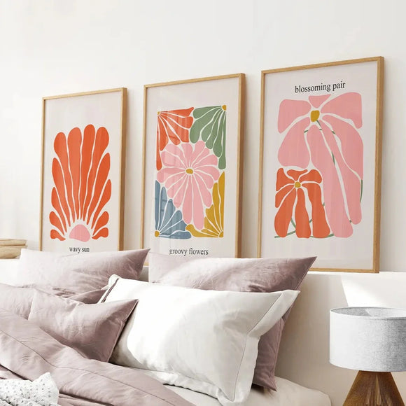 Henri Matisse Flower Market Colorful Poster on a wall above a bed with pillows and a lamp.