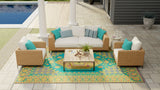 Outdoor patio furniture set with a Turkish Aqua rug on a patio area near a pool.