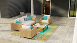 Outdoor patio set with wicker furniture and colorful Turkish Aqua rug on a patio.