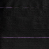 Close-up of dark fabric with a purple thread running horizontally.