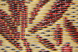 Close-up of a woven Wildflowers Cranberry pattern with red, yellow, and black colors.