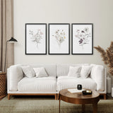 Modern living room with a white sofa, wooden coffee table, and 3 Piece Watercolor Floral Wall Art Set