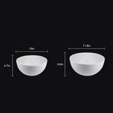 Two white bowls with measurements on a black background