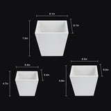White square planters with dimensions indicated on a black background
