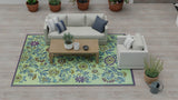 Living room with a floral Wildflowers Eggplant rug, gray sofa, and wooden coffee table.