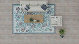 Top-down view of a living room with a floral rug, sofa, and coffee table.