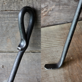 Wood Stove Fire Poker on a wooden background