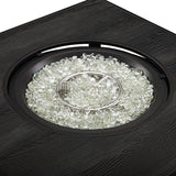 Black fire pit with glass beads and metal grate on a white background