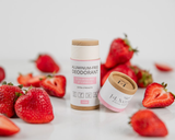 Two aluminum-free deodorant products with strawberries on a light background