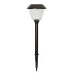 A single solar garden light with a dark bronze-finished stake and clear ribbed glass shade, shown against a plain white background.