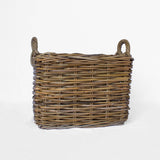 Wicker basket with handles on a white background
