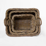 Set of three woven baskets of different sizes on a white background