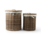 Two wicker laundry baskets with white lids on a white background