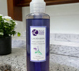Bottle of lavender bath and shower gel on a countertop with a blurred background
