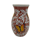 Ceramic vase with butterfly and floral design on a white background