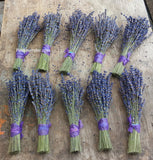 Bouquets of lavender with purple ribbons on a wooden surface, featuring 'FindLavender.com' branding.