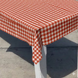 Red and white checkered tablecloth on a table outdoors.