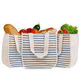 Striped tote bag filled with groceries on a white background