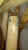 Wooden post with metal bracket and screw in a wooden structure