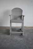 2' Standard Adirondack Chair - In Dining, Counter & Bar Heights on a concrete floor with a white wall background