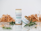 Aluminum-free deodorant and jar with rosemary on a light background