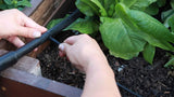 Person using a Watering - Raised Bed Drip Irrigation Kit