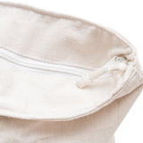 Close-up of a beige fabric with a drawstring on a white background