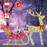Decorative LED reindeer with sleigh on a snowy background, featuring battery-powered and indoor/outdoor usage icons.