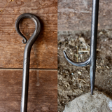 Fireplace Tongs and Fire Poker on a wooden surface and another on a natural stone background