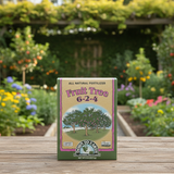 Box of Down to Earth Fruit Tree fertilizer on a wooden surface with a garden in the background