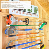Shed organizing system with tools and 'This's Up' sign on wooden wall