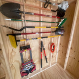 A collection of various hand tools and gardening equipment neatly organized on a wooden pegboard inside a shed or garage. The tools include a shovel, a string trimmer, a rake, a brush, a lawnmower attachment, a hedge trimmer, a wheelbarrow, and a pair of hedge shears.