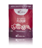 A bag of gf Jules Gluten Free All Purpose Flour, featuring a deep red and purple packaging design with illustrations of baked goods like a pretzel, cupcake, and cookies.