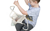Child using a mesh toy storage bag with a white background