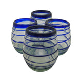 Four glass tumblers with blue rims on a white background