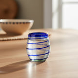 Glass with blue stripes on a wooden table