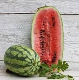 Heirloom Organic Georgia Rattlesnake Watermelon and a halved watermelon on a wooden surface