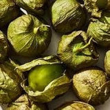 Heirloom Organic Green Tomatillo/ Mexican Husk Tomatos with husks on a white background