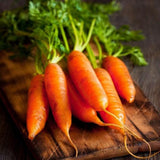 Heirloom Organic Little Finger Carrots on a wooden cutting board